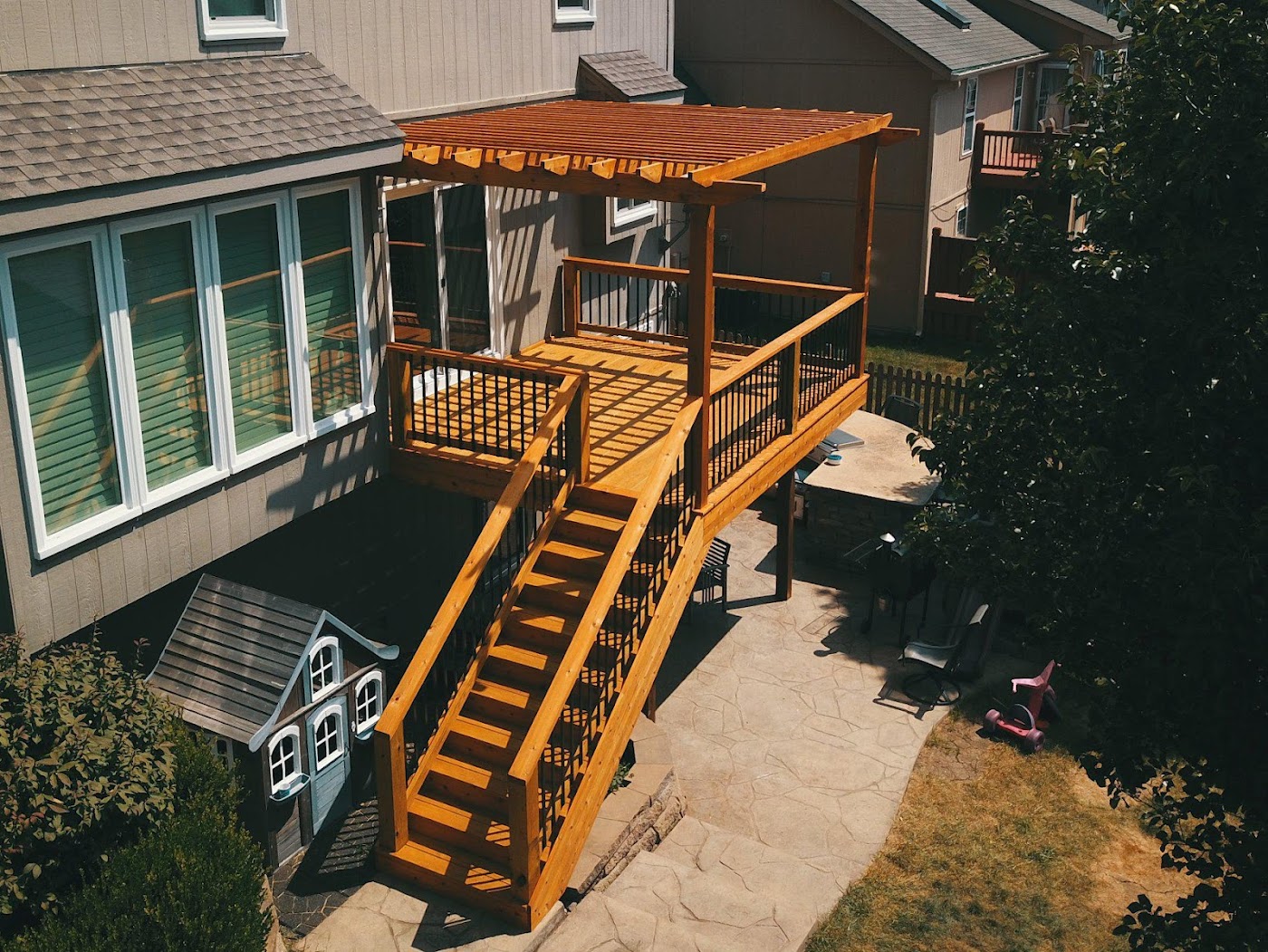 Custom cedar deck with a covered pergola built by High Valley Decks
